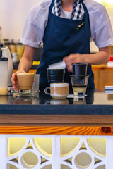 Waiter serving coffee at Vietnamese retro styled coffee shop