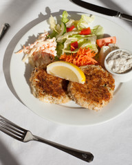 fish cakes on a plate with salad