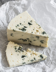 Piece of gorgonzola cheese on a grey background. Delicious food