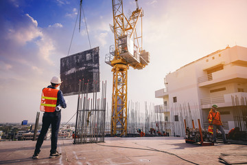 Smart civil architect engineer inspecting and working outdoors building side with blueprints....