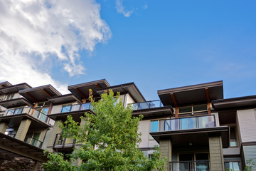 Raising roofs of residential building on blue sky backdrop