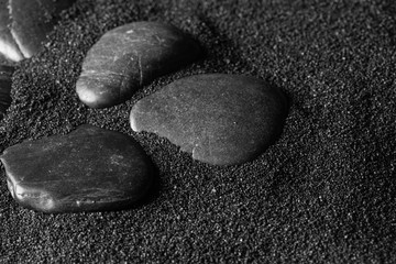  Black stone on a black sand dunes background. Black design.