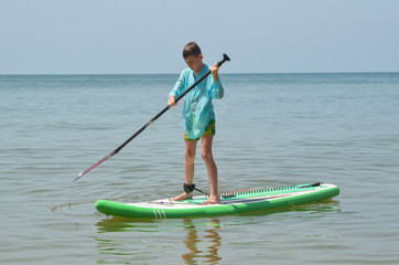 Active leisure in summer lifestyle. A boy rides on the sea in a kayak