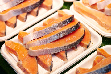 Frozen salmon on plastic tray 