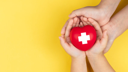world red cross day, adult and child hands holding red heart, healthcare, love and family insurance...