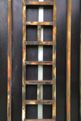 weathered rustic black metal steel door with patina look, grunge and dark background