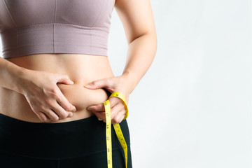 fat woman, fat belly, chubby, obese woman hand holding excessive belly fat with measure tape, woman...
