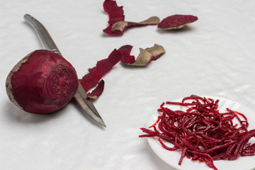 Fermented beets on plate. Beets and knife. Peeling vegetables