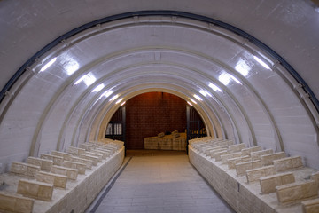 White bridge underpass with red brick wall at the end