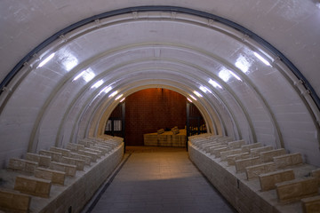 White bridge underpass with red brick wall at the end