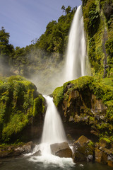 Beautiful Patagonian waterfall in a forest lit by the rising sun of Patagonia