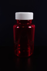 A jar of pills on a black background. Isolate. Front view.