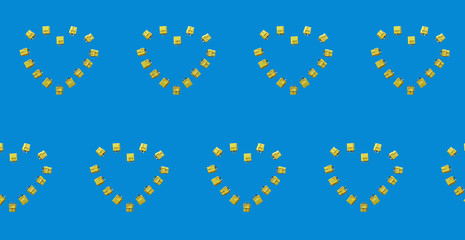 The yellow power connectors are folded in the shape of a heart. The connectors are designed to power the UAV XT60. The heart repeats. Pattern on a blue background.