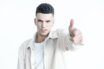 Aggressive young man pointing at camera. Portrait of handsome confident young man with piercing pointing with finger and looking at camera. Gesture concept