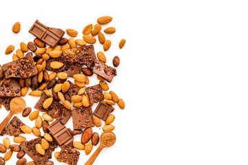 Chocolate frame. Broken slices and nuts on white background top-down copy space