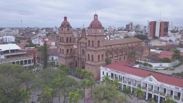 Aerial view of the city of Santa Cruz de la Sierra. Camera orbits around Cathedral Basilica of St. Lawrence. Clip without any type of color grading and is in the flat profile
