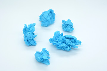 crumpled blue paper isolated on white background, snowball concept, creative crisis, business crisis