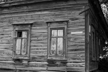 old wooden house with windows, dilapidated housing