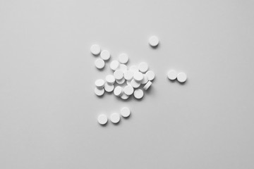 many white pills on a light background