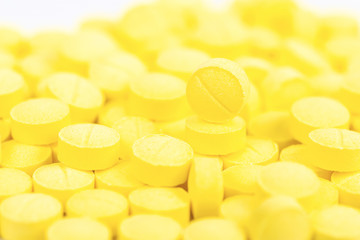 Selective focus of yellow medical pills..