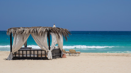 Marsa Matruh, Egypt. Elegant gazebo on the beach. Amazing sea with tropical blue, turquoise and green colors. Relaxing context. Nobody on the beach. Fabulous holidays. Mediterranean Sea. North Africa