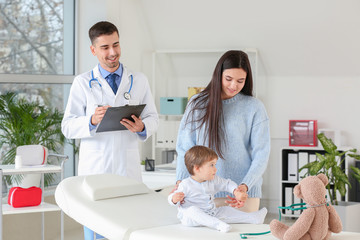 Obraz premium Woman with little baby visiting pediatrician in clinic