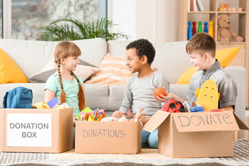 Little children with donations at orphan home