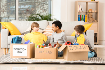 Little children with donations at orphan home