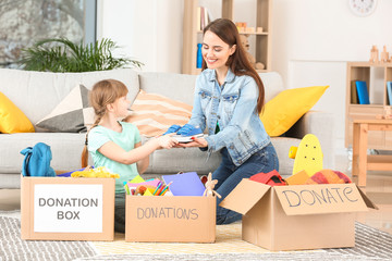 Volunteer with donations and little girl at orphan home