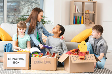 Volunteer with donations and children at orphan home