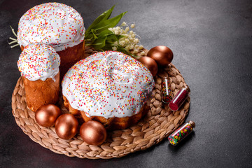 Easter eggs gold and bronze and Easter cake on a dark background