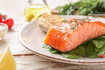 Cooked salmon fillet with herbs on plate