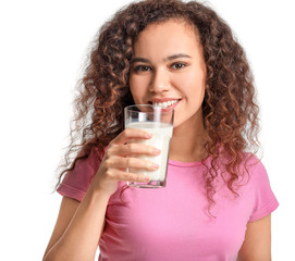 Young African-American woman with milk on white background