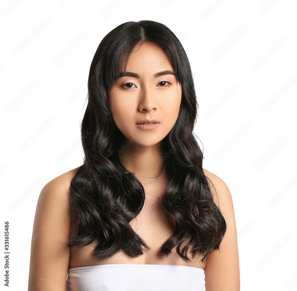 Wall mural Young Asian woman with beautiful long hair on white background