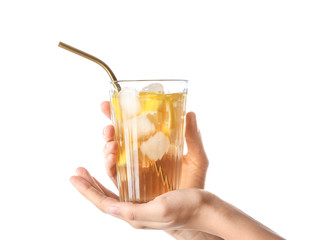 Female hands with cold tea in glass on white background