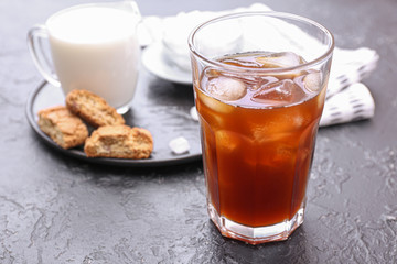 Glass of tasty iced coffee on table