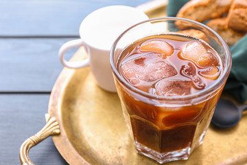 Glass of tasty iced coffee on table