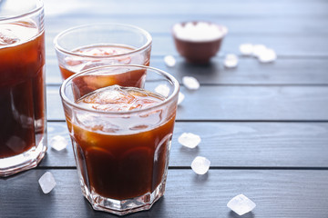 Glasses of tasty cold coffee on table