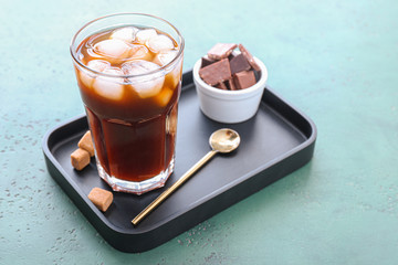 Glass of tasty iced coffee on table