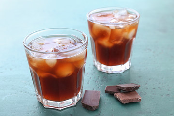 Glasses of tasty cold coffee on table