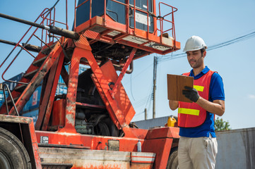 Foreman holding clipboard working at Container cargo harbor. Business Logistics import export shipping concept.