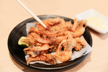 Izakaya Fried shrimp with chopsticks on white background