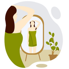 beautiful young woman after shower looking at herself in floor mirror. Girl wrapped a green towel. Visible hairy armpit. Concept Body positive and feminism. 