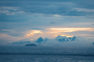 sunset over the sea, landscape in Antarctica with mountains and glaciers 