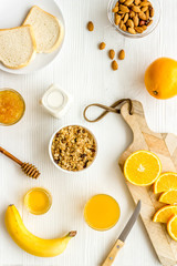 Granola for healthy breakfast. Still life composition with fruits and toast on white background top-down
