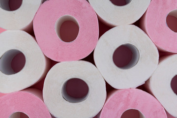 Rolls of white and pink toilet paper. Shortage of toilet paper.