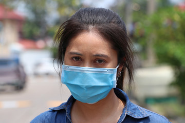 Asian woman wearing the mask for prevent germs. Tiny Particle or Covid 19 protection. Concept of...