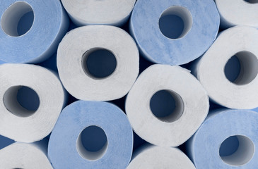 Rolls of white and blue toilet paper. Shortage of toilet paper.