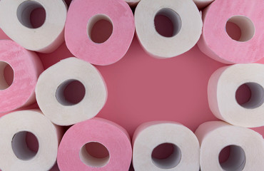 .Rolls of white and pink toilet paper on a pink background copy space. Shortage of toilet paper flat lay.