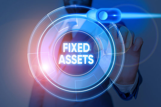 Writing note showing Fixed Assets. Business concept for longterm tangible piece of property or equipment a firm owns